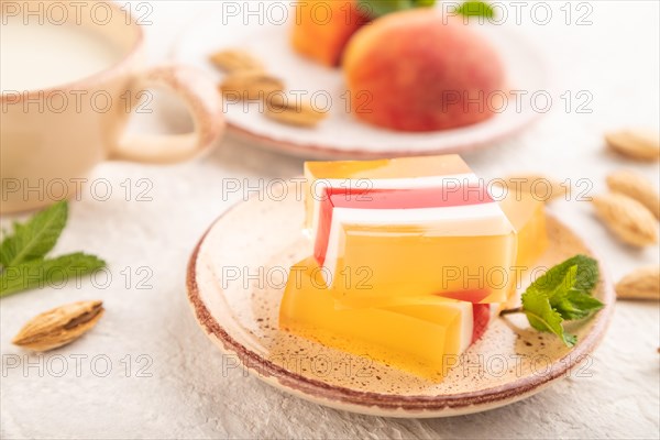 Almond milk and peach jelly on gray concrete background. side view, close up, selective focus