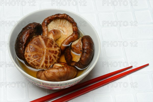 Dried shiitake mushrooms in a bowl, soaked in water