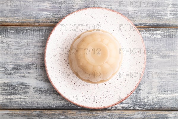 Buckwheat milk jelly on gray wooden background. top view, flat lay