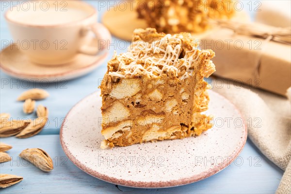 Traditional lithuanian cake shakotis with cup of coffee on blue wooden background and linen textile. side view, close up, selective focus