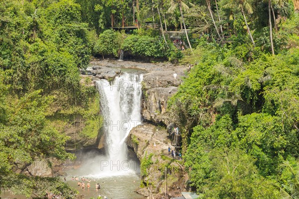 Tegenungan waterfall, Bali island, Ubud, Indonesia. Jungle, tropical forest, daytime with cloudy sky