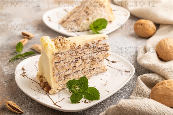 Walnut and almond cake on brown concrete background and linen textile. side view, close up