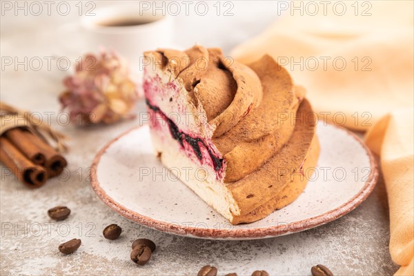 Zephyr or marshmallow cake with cup of coffee on brown concrete background and orange textile. side view, close up, selective focus