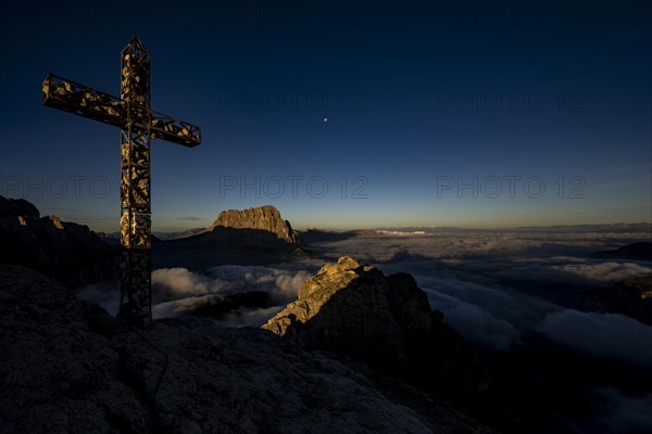 Summit cross of the large Cirrspitze with Dolomite peaks in the background, Corvara, Dolomites, Italy, Europe