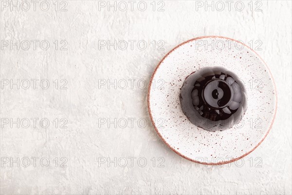 Black currant and grapes jelly on gray concrete background. top view, flat lay, copy space