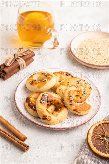 Homemade asian salted cookies, cup of green tea on gray concrete background and linen textile. side view