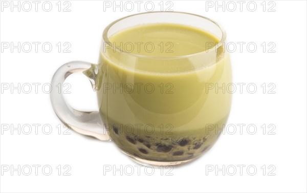 Bubble tea with pistachio and caramel in glass isolated on white background. Healthy drink concept. Side view, close up