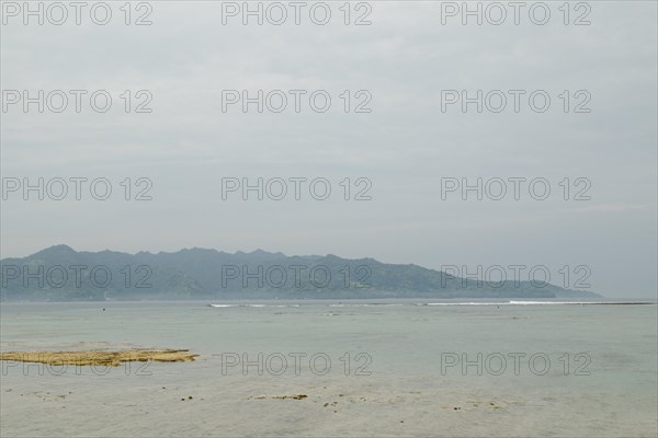 Lombok and Gili Air islands, overcast, cloudy day, sky and sea. Vacation, travel, tropics concept, no people. Sunny day, sand beach