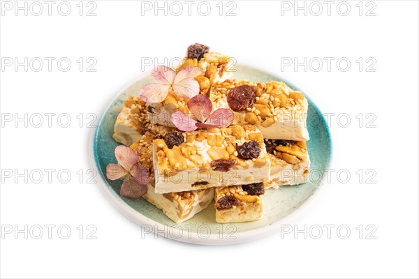 Traditional candy nougat with nuts and sesame isolated on white background. side view, close up
