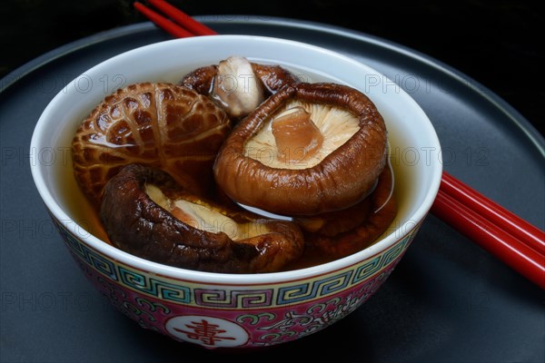 Dried shiitake mushrooms in a bowl, soaked in water