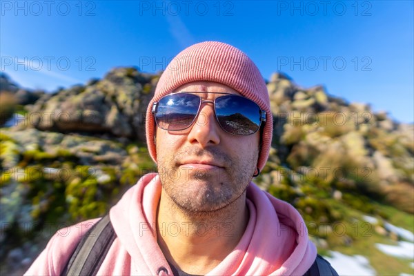 Close-up portrait of a man on the top of the mountain when trekking