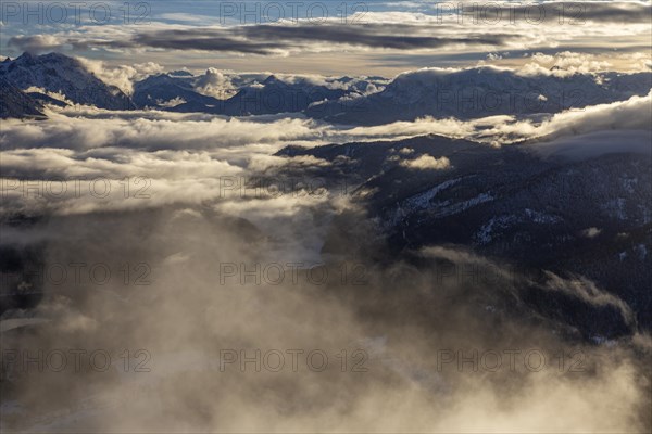 Mountain peaks rise above high fog in the evening light, winter, snow, view from Herzogstand to Karwendel Mountains, Bavarian Alps, Upper Bavaria, Bavaria, Germany, Europe