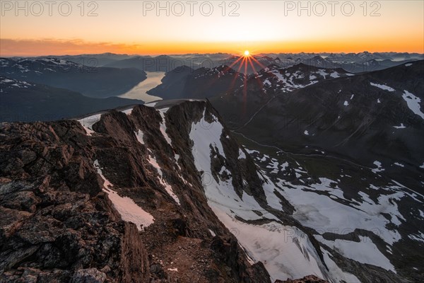 View of mountains and fjord Faleidfjorden, sun star at sunset, summit of Skala, Loen, Norway, Europe