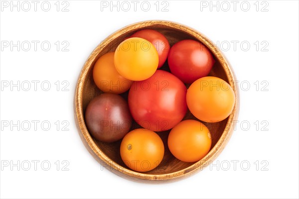 Red. yellow cherry tomatoes in wooden bowl isolated on white background. Top view, flat lay