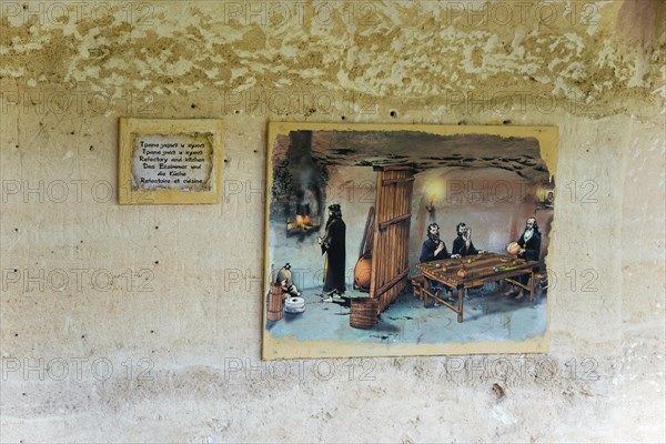 Mural of a historical scene with informative accompanying panel in a cave, dining room and kitchen, Aladja Monastery, Aladja Monastery, Aladzha Monastery, medieval rock monastery, cave monastery in limestone cliff, Varna, Black Sea coast, Bulgaria, Europe