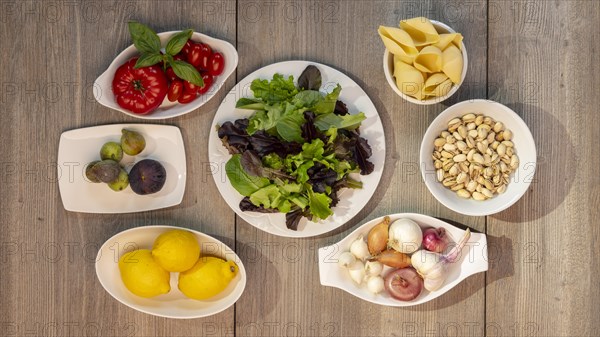 Food photography Lettuce, tomatoes, lemon, garlic, pistachios, figs, onion, pearl onion, shell pasta