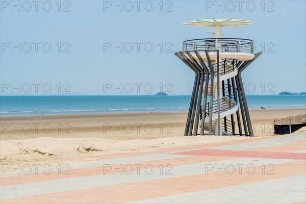 Lookout tower with spiral ramp on beach with ocean in background in South Korea