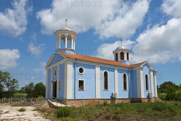 A small church with blue walls and white domes under a clear blue sky surrounded by nature, Sveti Nikola, Kavarna, Dobrich, Bulgaria, Europe