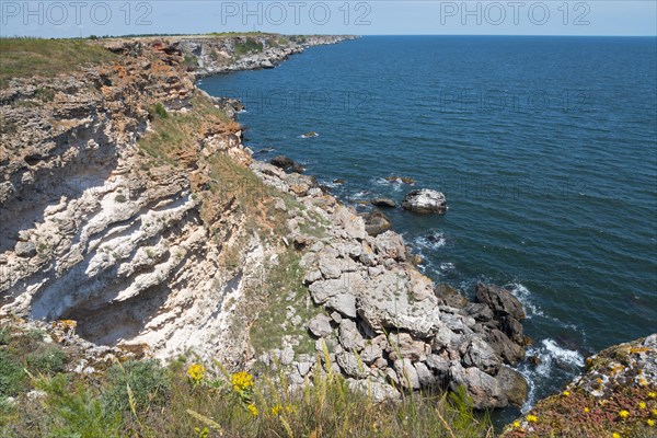 A steep cliff on a quiet coast with a view of the blue sea and clear sky, cliff, Kamen Bryag, Bryag, stone shore, Dobrich, Bulgaria, Europe