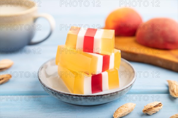 Almond milk and peach jelly on blue wooden background. side view, close up, selective focus