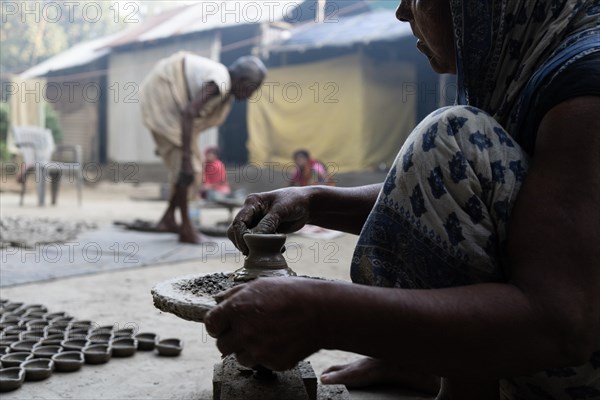 BARPETA, INDIA, NOVEMBER 7: A woman makes earthen lamps or Diyas at her residence ahead of the Diwali Festival in a village in Barpeta, India on November 7, 2023. Earthen lamps are a significant part of Indian culture and tradition