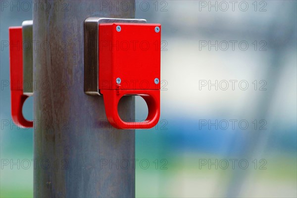 A bright red emergency brake on an underground escalator, unlabelled, Munich, Bavaria, Germany, Europe