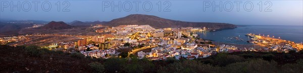 Los Cristianos in the evening at sunset, blue hour, panoramic shot with harbor, volcanoes and sea, Tenerife, Canary Islands, Spain, Europe