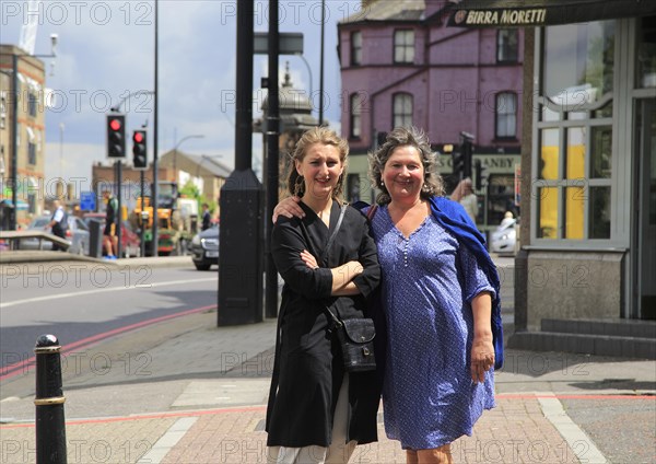 Middle aged mother and her daughter together on street in London, England, UK, model released