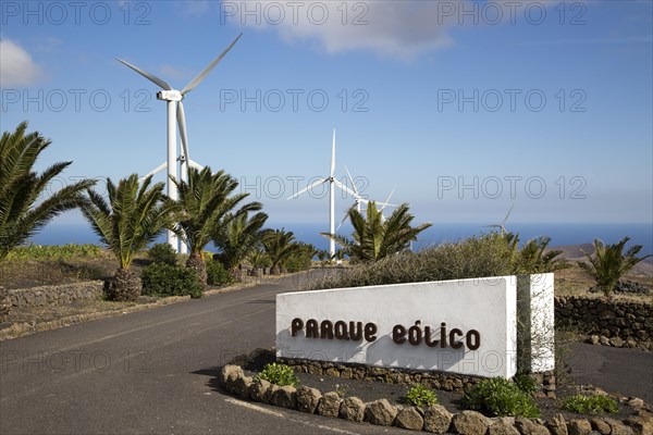 Turbines and sign at Parque Eolico de Lanzarote wind farm, Lanzarote, Canary Islands, Spain, Europe