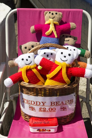 Homemade woollen teddy bears for sale with honesty money box, Cornwall, England, UK