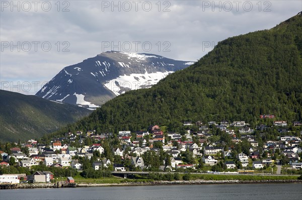 Suburban housing and landscape of snow on mountain side, Tromso, Norway, Europe