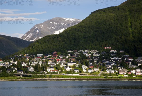 Suburban housing and landscape of snow on mountain side, Tromso, Norway, Europe