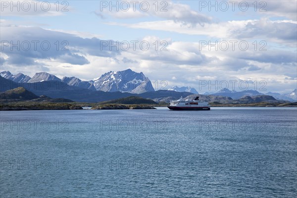 Hurtigruten ferry ship jagged mountains near Ornes, Nordland, Norway, Europe