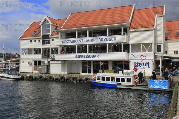 Waterside buildings and boats Vagen harbour, by Torget fish market, Bergen, Norway, Europe