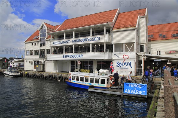 Waterside buildings and boats Vagen harbour, by Torget fish market, Bergen, Norway, Europe