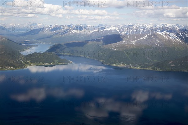 Broken cumulus cloud seen from above looking down over mountains, western Norway near Tromso