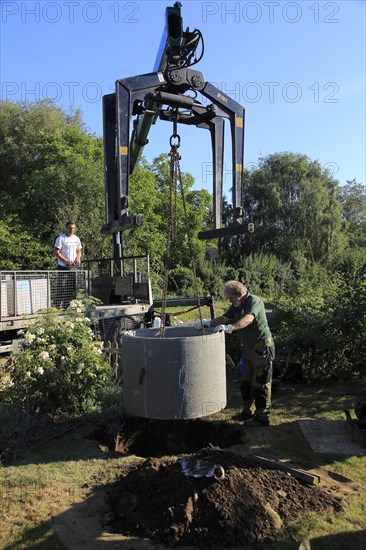 Delivery and installation of concrete ring for domestic septic tank system, Suffolk, England, UK