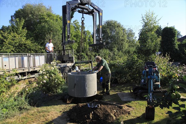 Delivery and installation of concrete ring for domestic septic tank system, Suffolk, England, UK