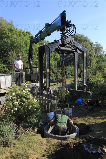 Delivery and installation of concrete ring for domestic septic tank system, Suffolk, England, UK