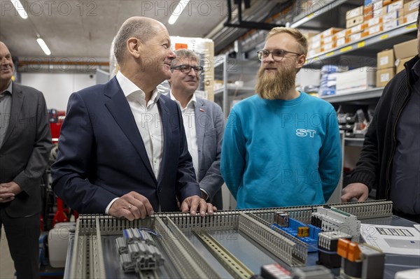 Federal Chancellor Olaf Scholz, SPD, visits the company ST Gebäudetechnik in Potsdam. Here in conversation with employees at a control cabinet. 20.01.2024