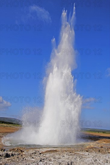 The geyser Strokkur fires steam and boiling water up to a height of around 20m, at Storr Geysir, Haukadalur, south-central Iceland