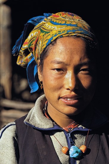 Portrait of pretty Bhotia girl with headscarf at the village of Chhinga in the Mustang region of west Nepal