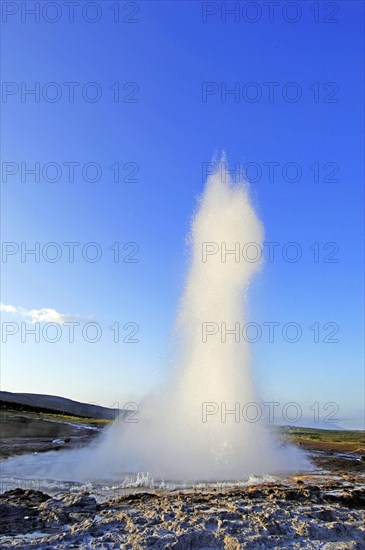 The geyser Strokkur fires steam and boiling water up to a height of around 20m, at Storr Geysir, Haukadalur, south-central Iceland