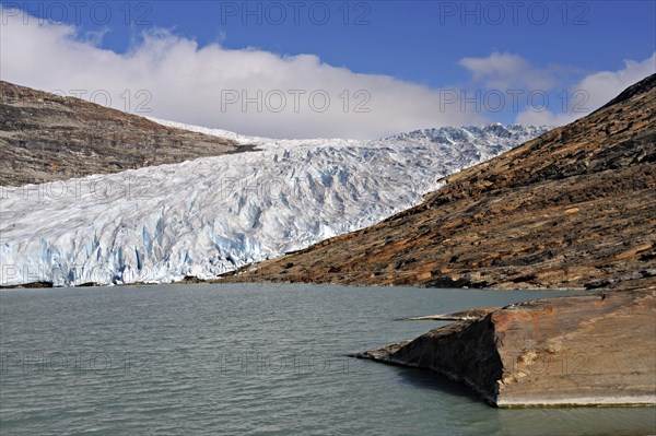 Glacier tongue or snout from the Svartisen ice-cap falls into a meltwater lake, Osterdalen, Norway, Europe