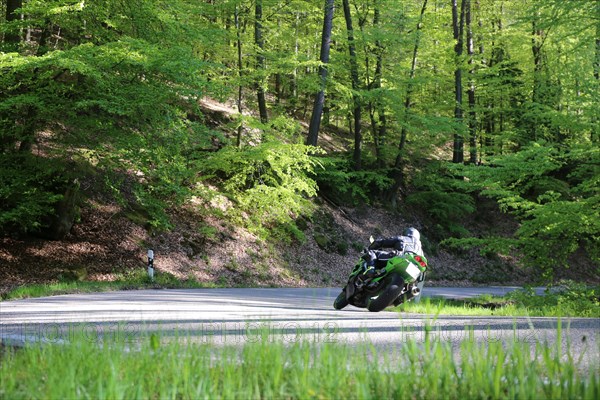 Sporty motorcyclist on a trip into the countryside (Edenkoben Valley, Palatinate Forest)