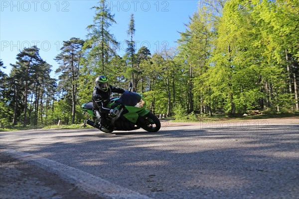 Sporty motorcyclist on a trip into the countryside (Edenkoben Valley, Palatinate Forest)