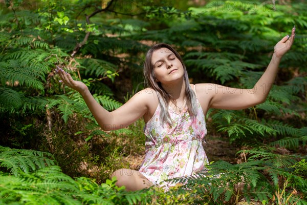 Young woman bathing in the forest (Shinrin Yoku), nature therapy from Japan