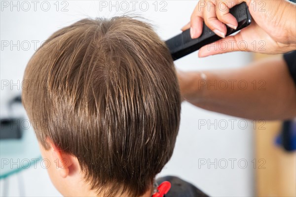Boy gets a new haircut at the hairdresser
