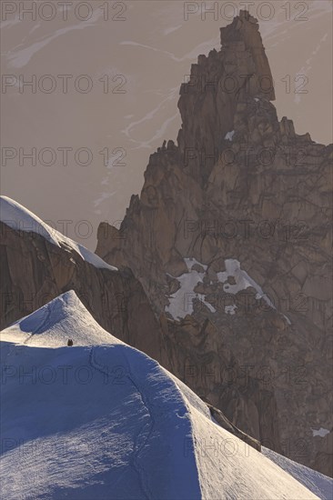 Mountaineer on glacier at sunrise, Mont Blanc Massif, French Alps, Chamonix, France, Europe