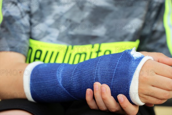 Close-up of a boy with an arm in plaster